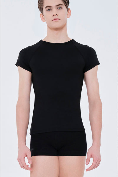 Person wearing a black t-shirt and black shorts on a white background
