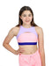 Young girl wearing a colorful sports bra and pink pants on a white background