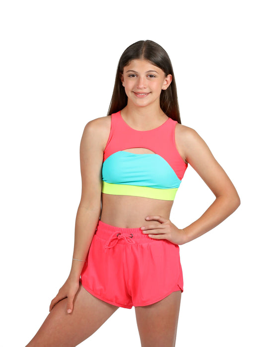 Young girl wearing a colorful two-piece swimsuit on a white background