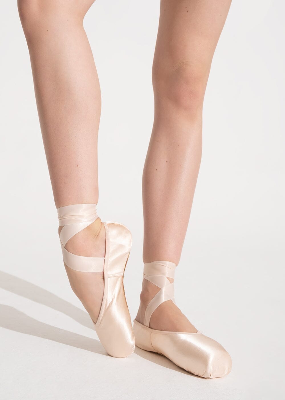 Ballet shoes with ribbons on a white background