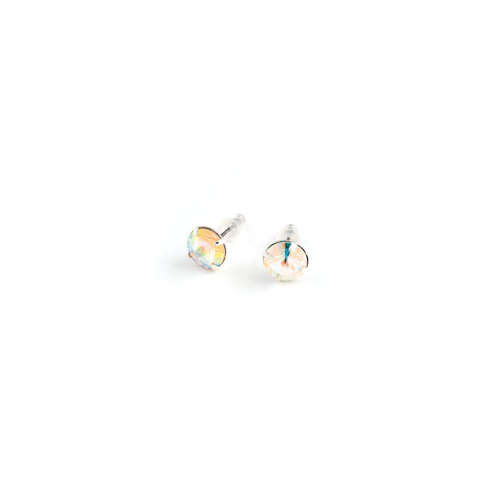 Pair of round stud earrings on a white background