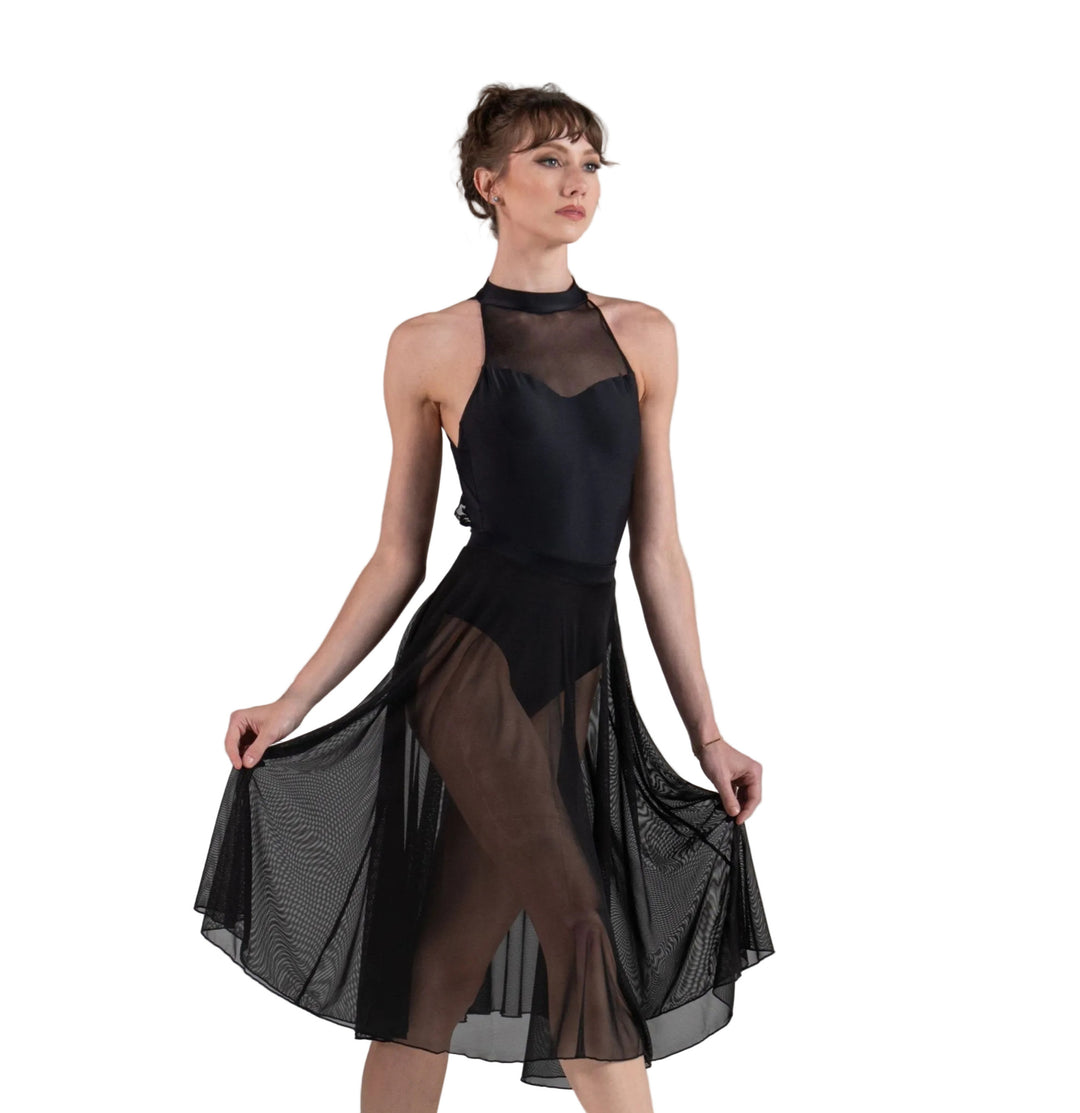Dancer in a black leotard and skirt on white background