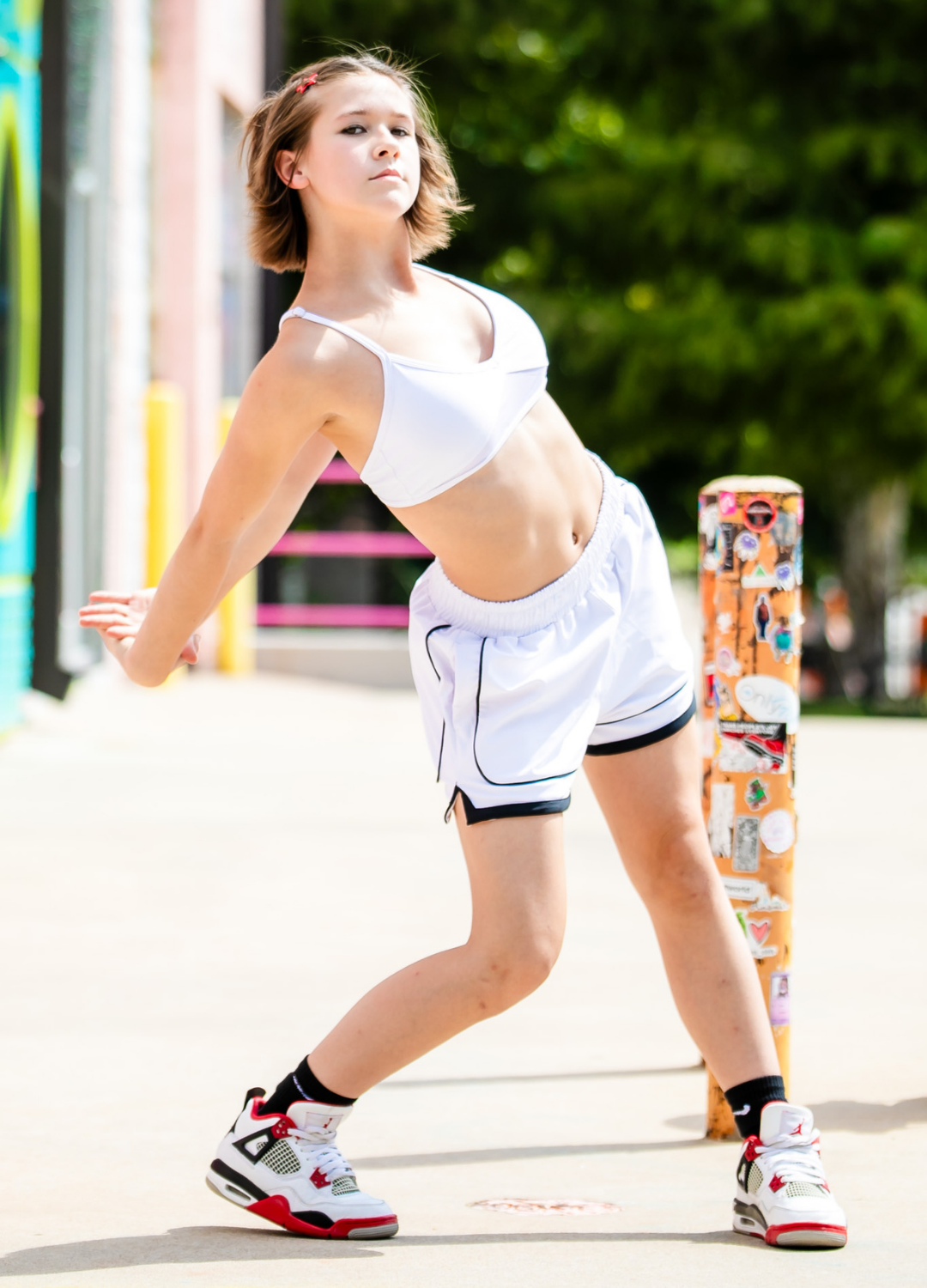 Person in athletic wear walking outdoors with colorful background