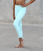 Person wearing light blue leggings on a concrete surface
