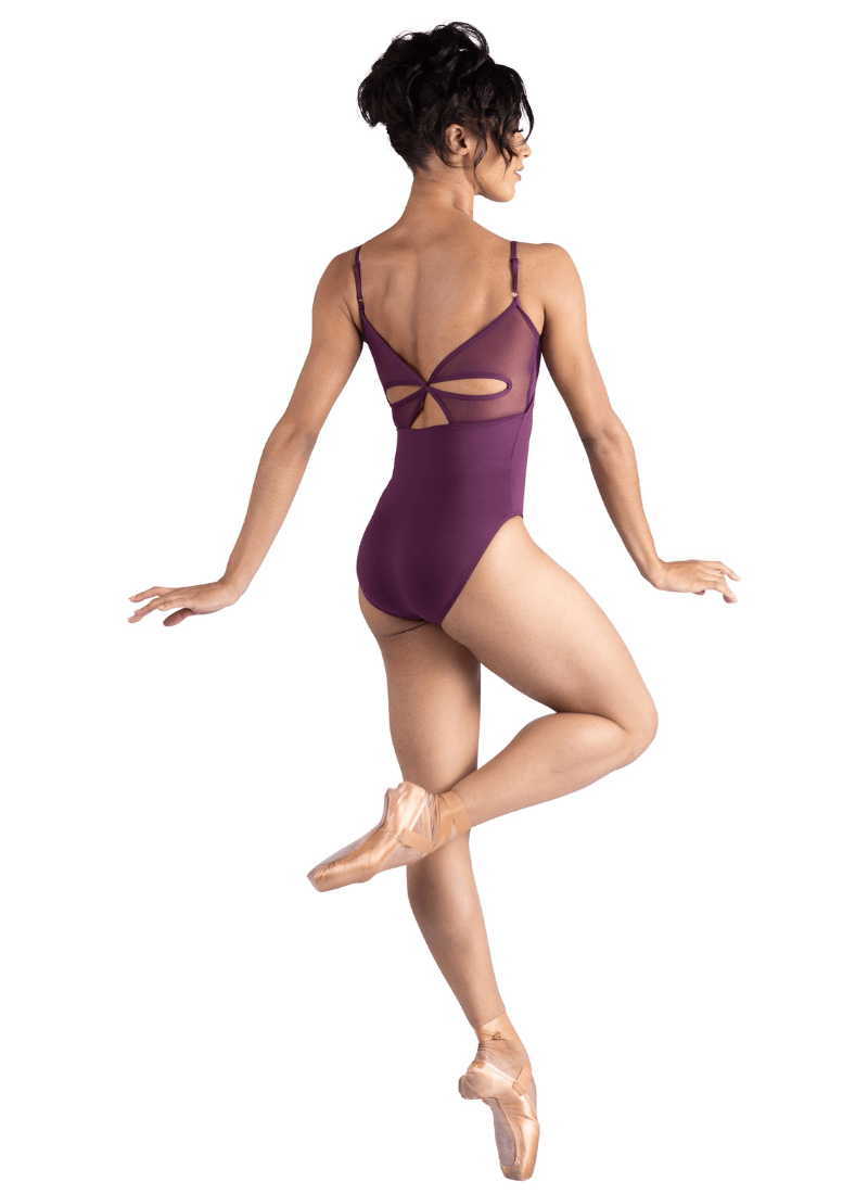 Ballerina in a purple leotard on a white background