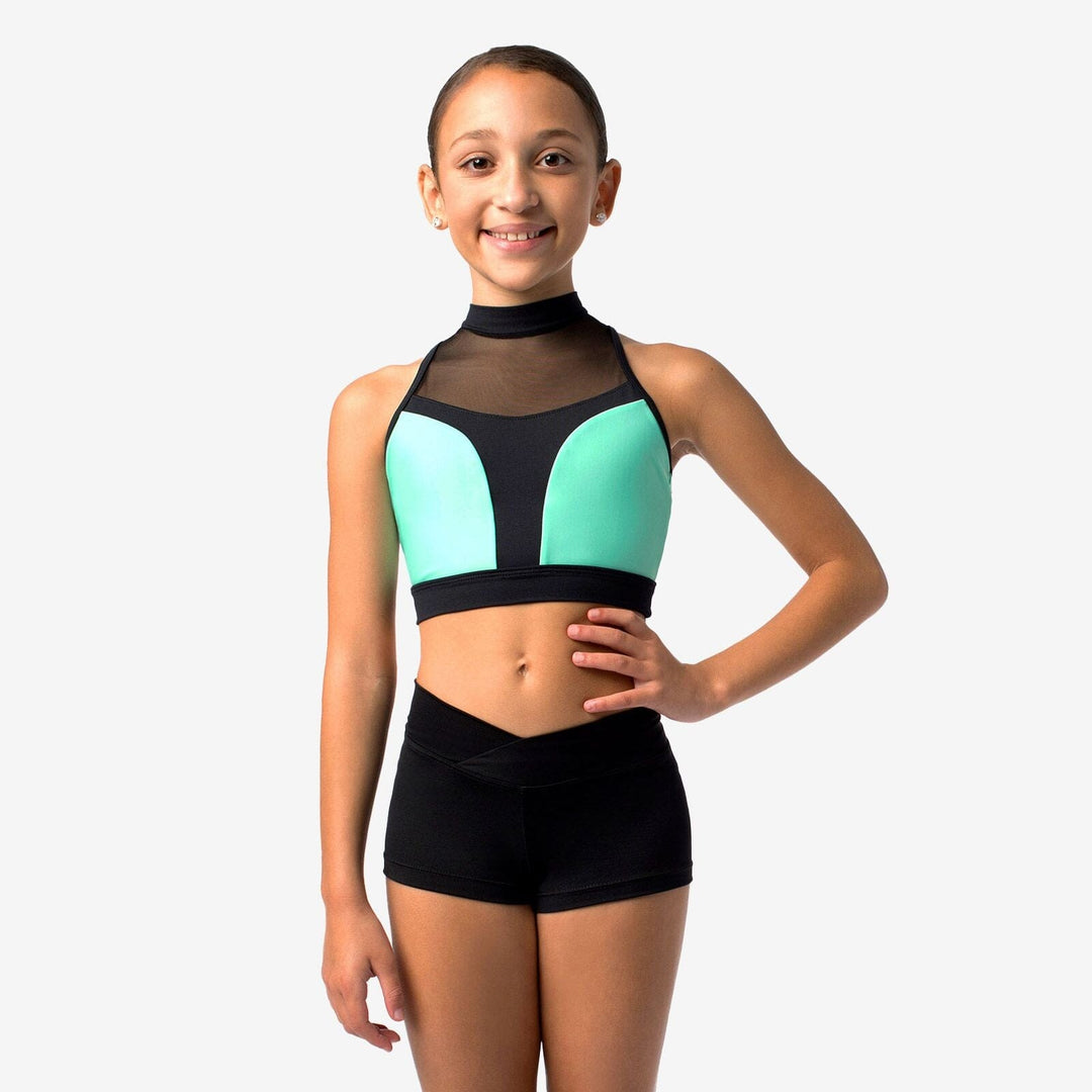 Girl wearing a black and teal sports bra and shorts on a white background