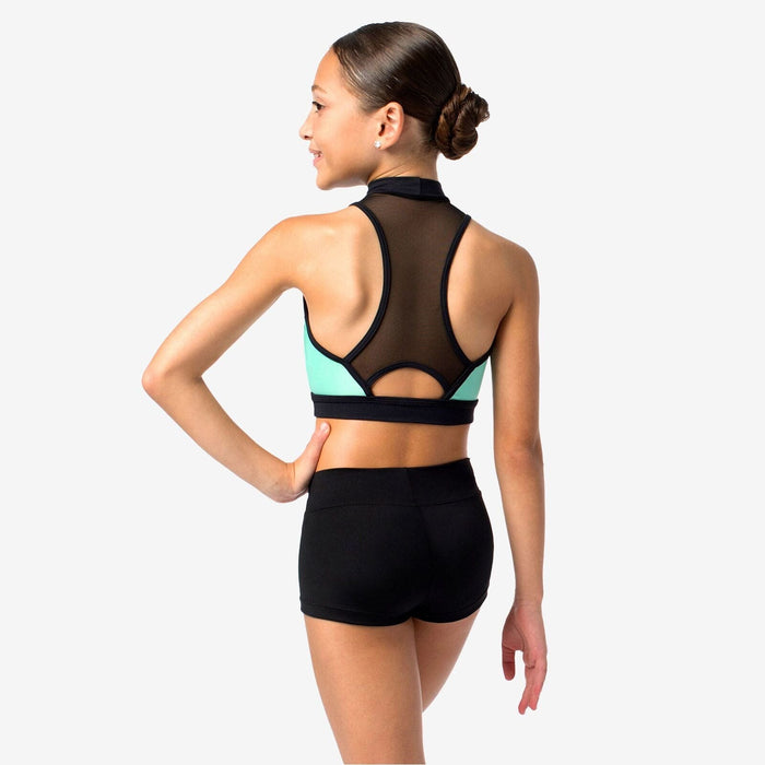 Woman wearing a black and teal sports bra and shorts on a white background