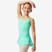 Young girl in a light green dance outfit posing against a white background