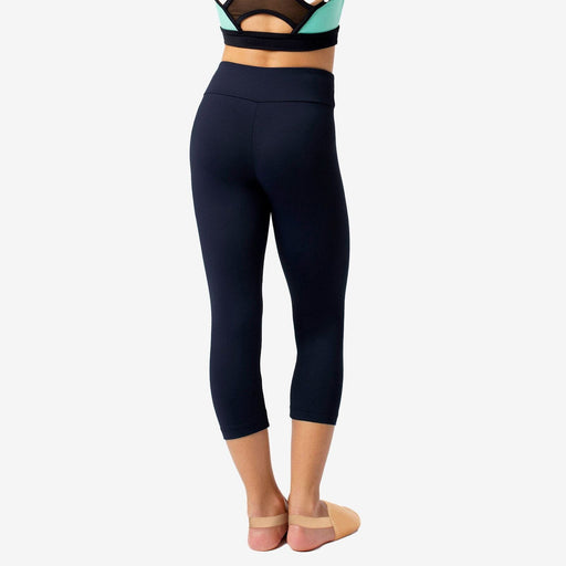 Person wearing black athletic leggings on a white background