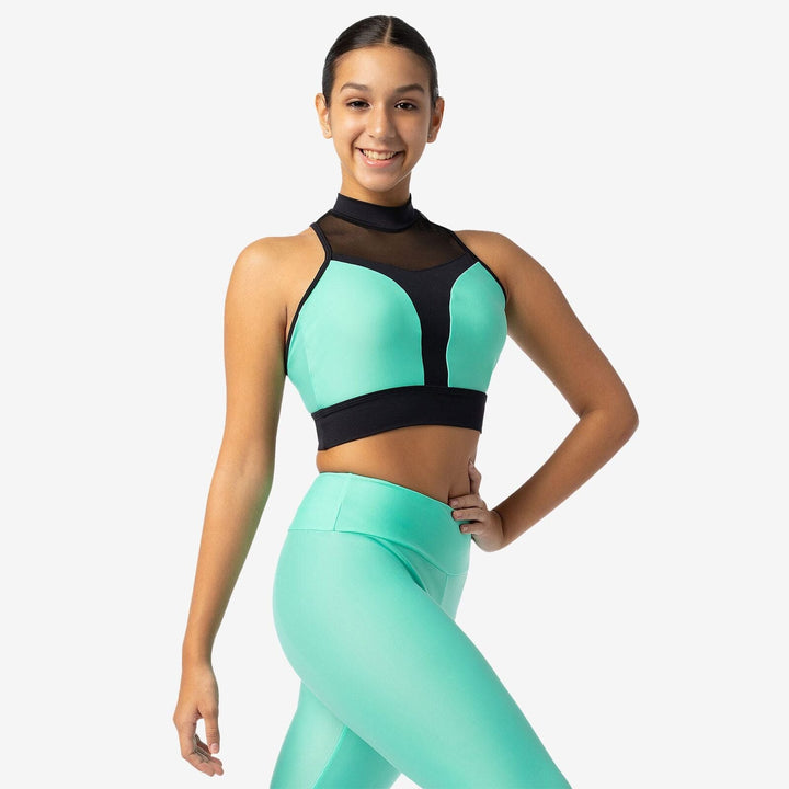 Woman wearing a green and black sports outfit on a white background