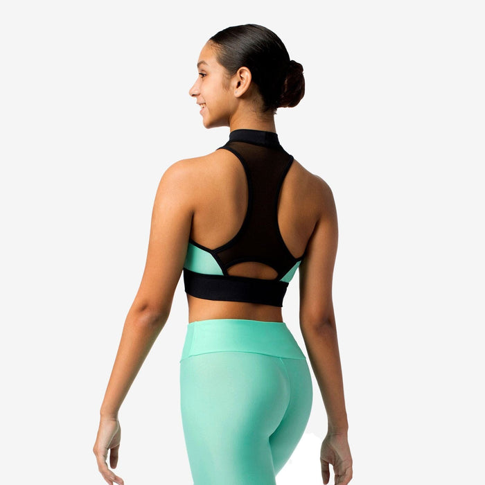 Woman wearing a black sports bra and teal leggings on a white background