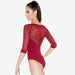 Red lace bodysuit worn by a model on a white background