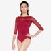 Woman wearing a red lace bodysuit on a white background