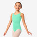 Young girl wearing a green leotard on a white background
