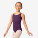 Young girl wearing a purple leotard on a white background