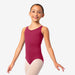 Young girl wearing a maroon leotard on a white background