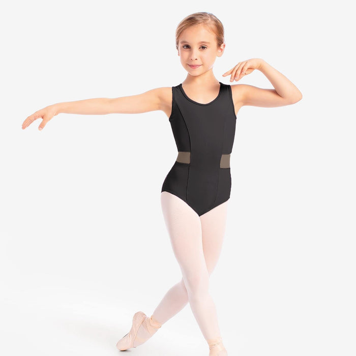 Young girl in a black leotard and white tights posing on a white background
