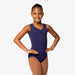 Young girl wearing a purple leotard on a white background
