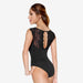 Black lace bodysuit worn by a model on a white background