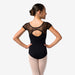 Ballerina wearing a black leotard with sheer mesh details on a white background