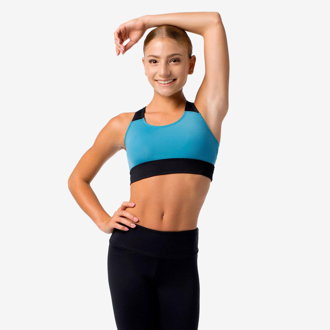 Woman wearing a blue and black sports bra and leggings on a white background