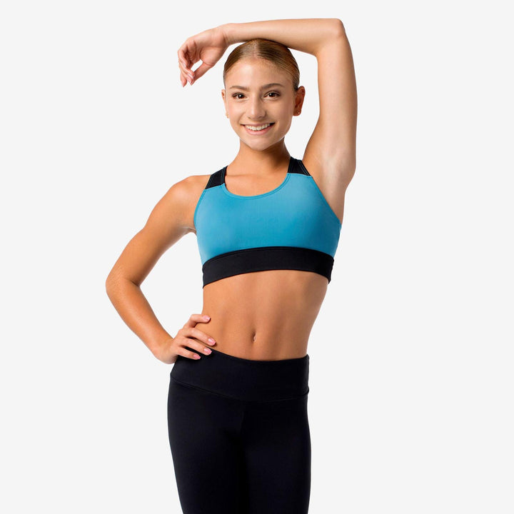Woman wearing a blue and black sports bra and leggings on a white background