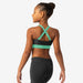 Woman wearing a green and black sports bra on a white background