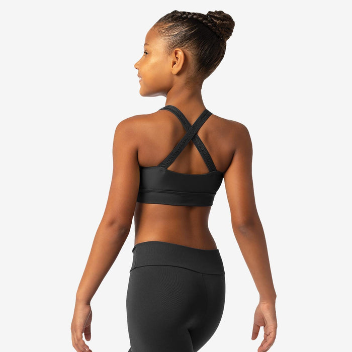 Woman wearing a black sports bra and leggings on a white background