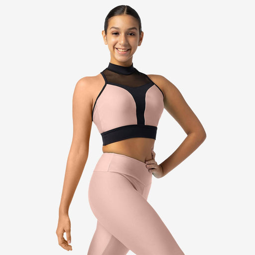 Woman wearing a pink and black sports bra and leggings on a white background
