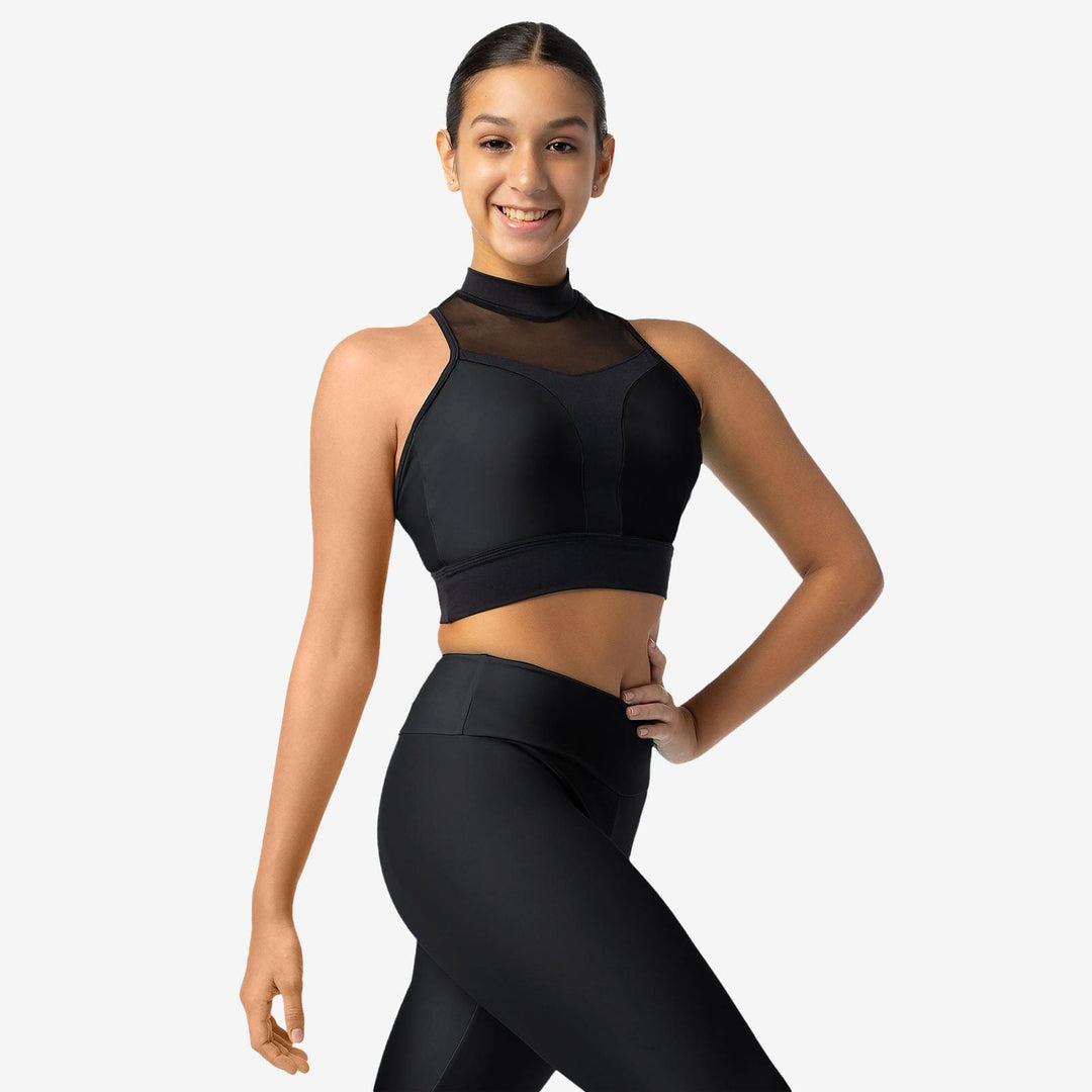 Woman wearing a black sports bra and leggings on a white background