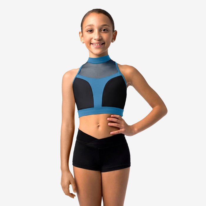 Young girl wearing a blue and black sports bra and shorts on a white background