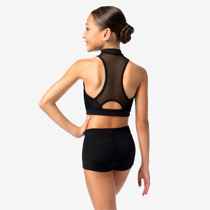 Woman wearing a black sports bra and shorts on a white background