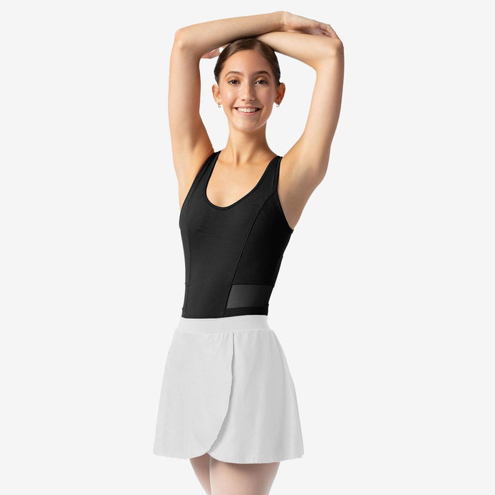 Dancer in a black leotard and white skirt on a plain background