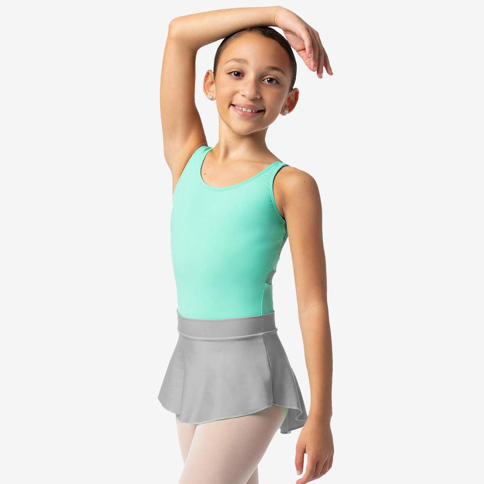 Young girl in a mint green leotard and gray skirt posing against a white background