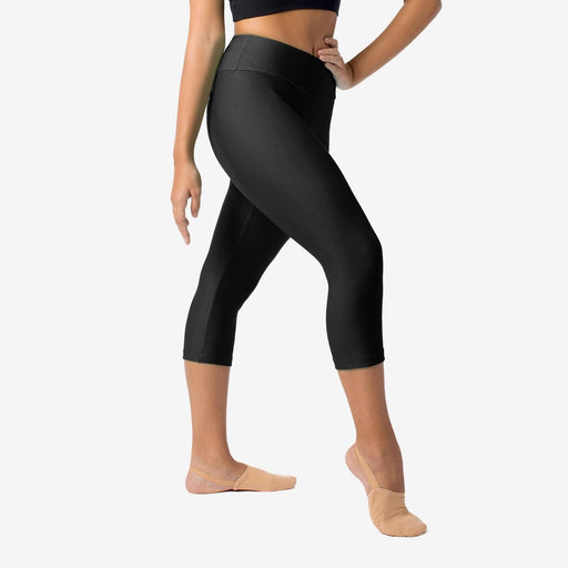 Person wearing black capri leggings on a white background