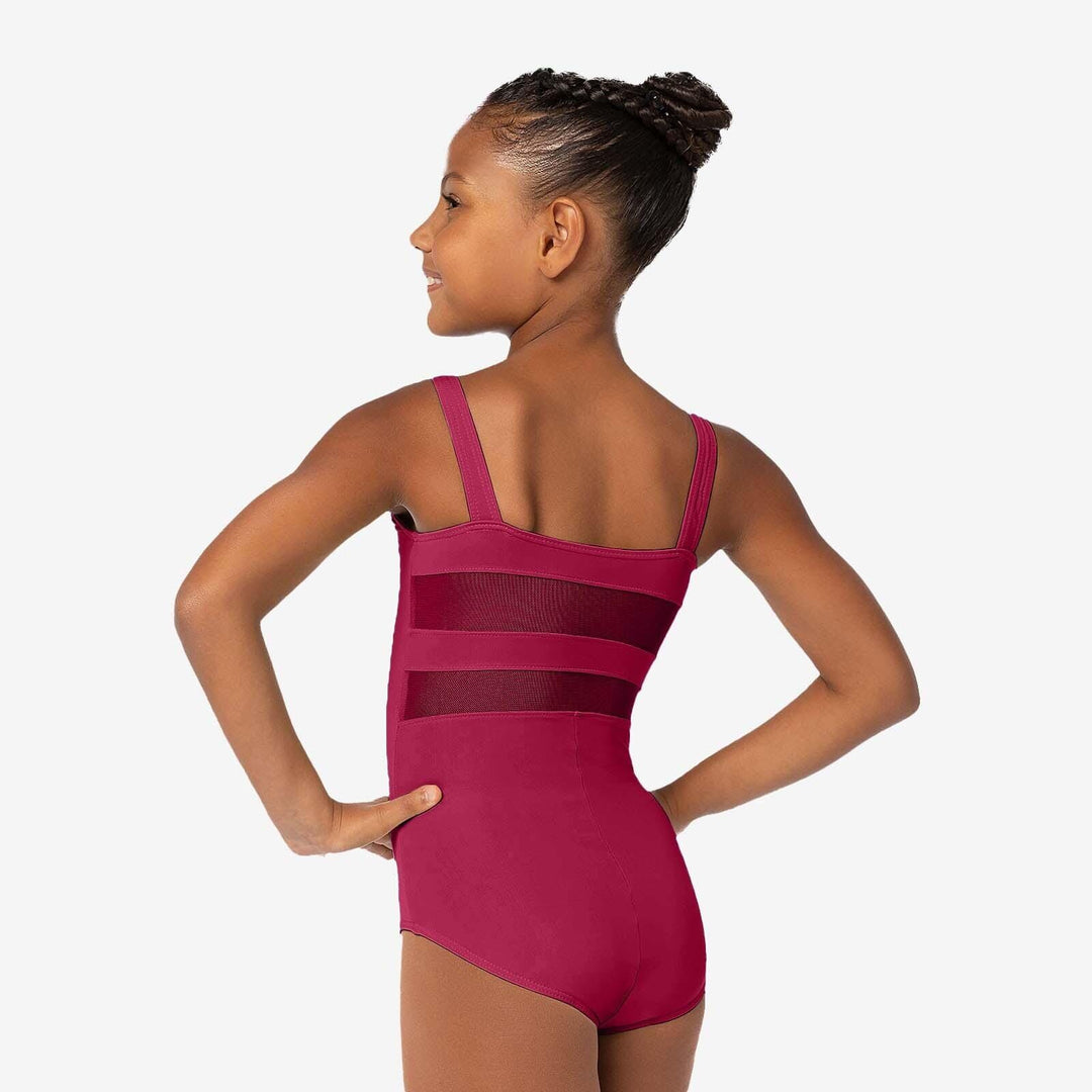 Young girl wearing a pink leotard on a white background
