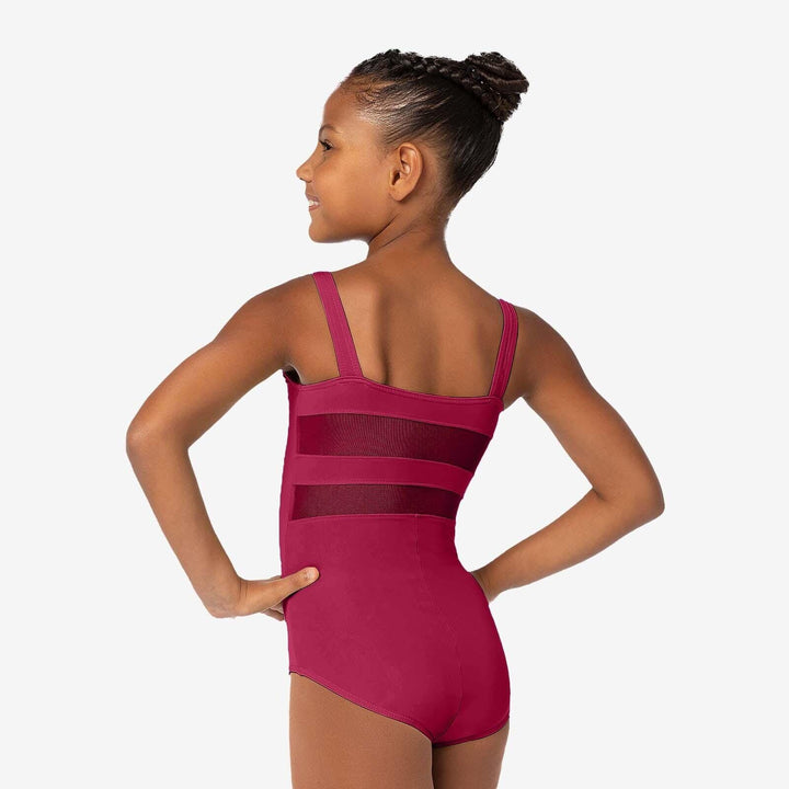 Young girl wearing a pink leotard on a white background