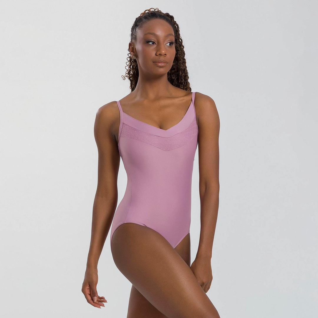 Woman wearing a pink swimsuit against a plain background