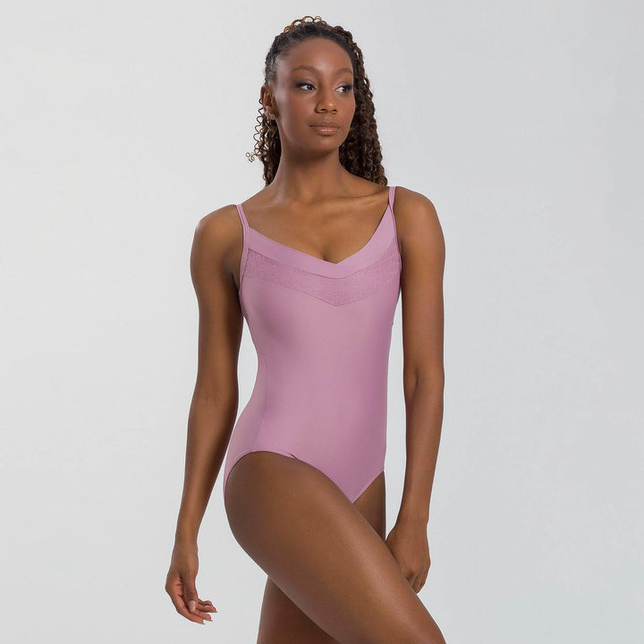 Woman wearing a pink swimsuit against a plain background