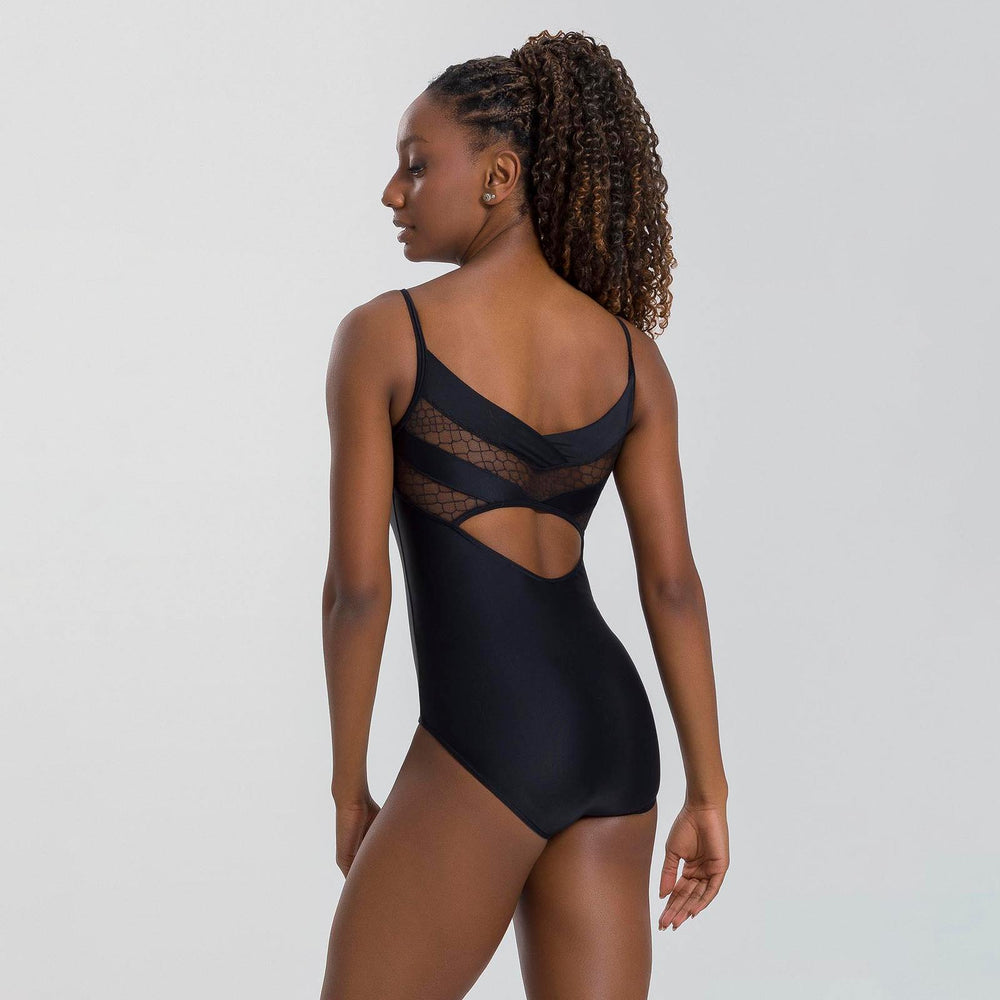 Woman wearing a black bodysuit with mesh panels on a light gray background