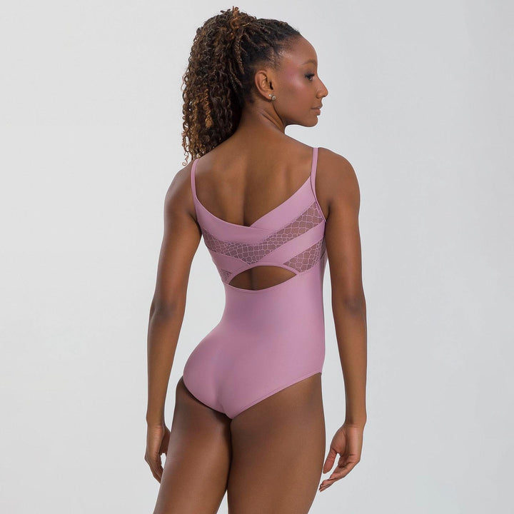 Woman wearing a pink swimsuit with mesh panels on a white background