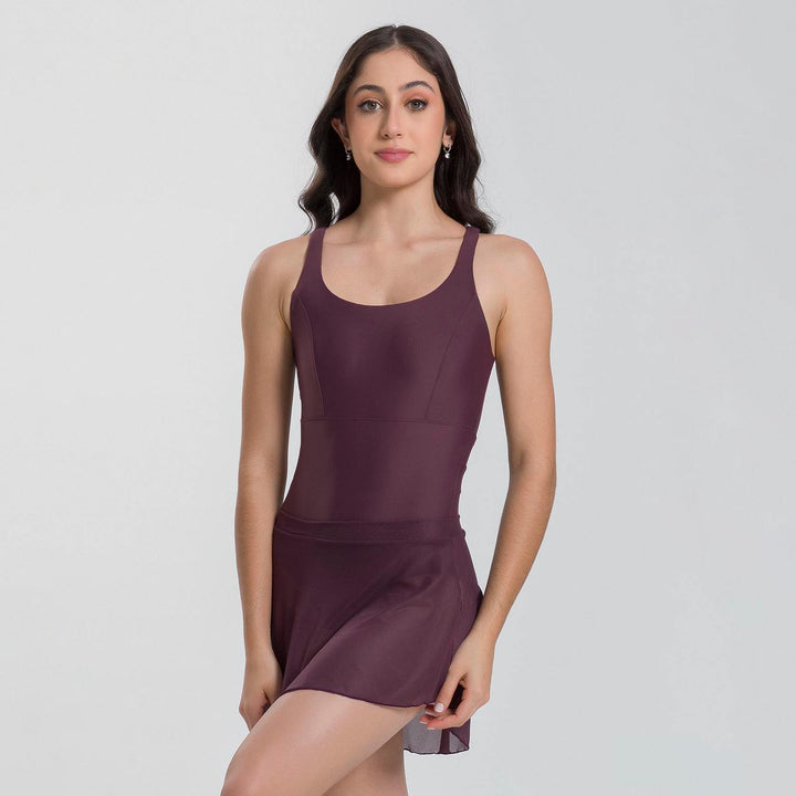 Woman wearing a maroon tank top and skirt set on a white background