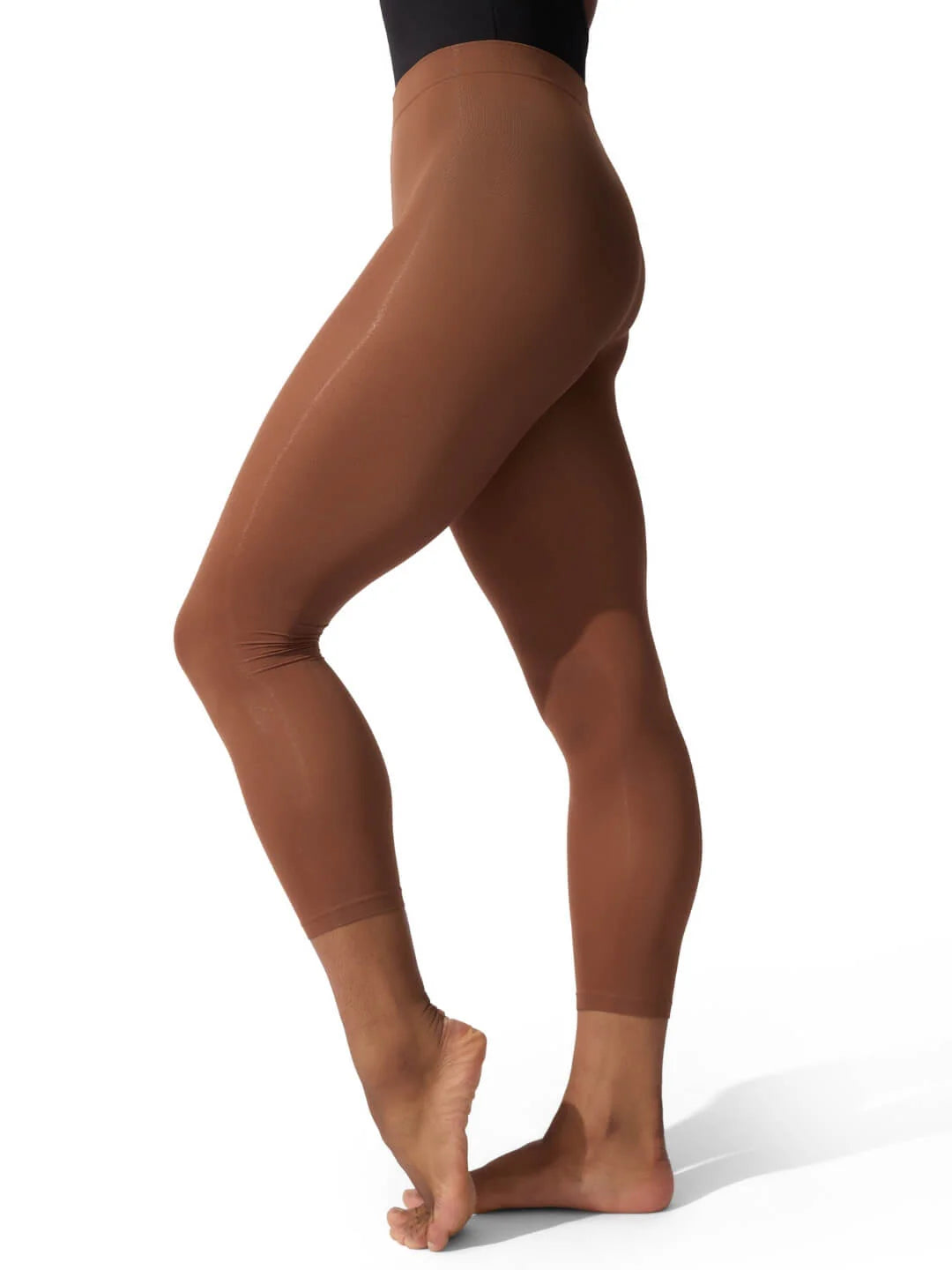 Brown leggings worn by a person on a white background