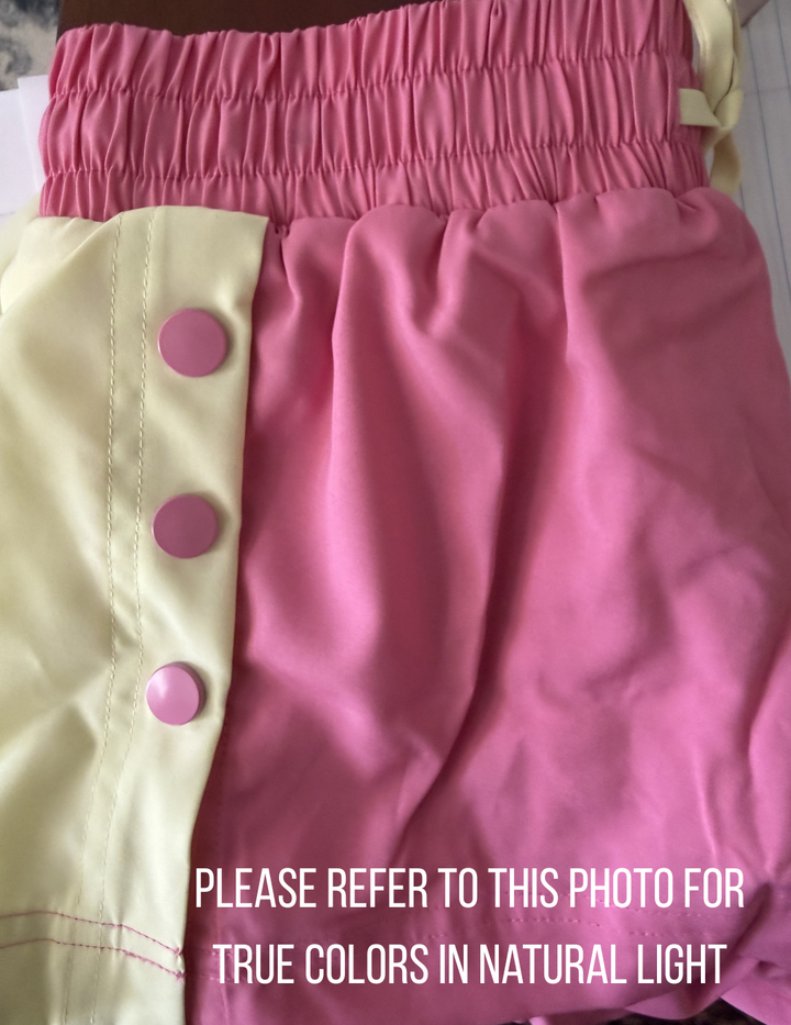 Pink and yellow garment with buttons on a white background