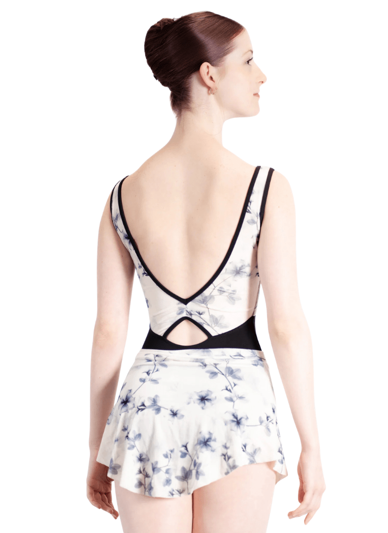 Woman wearing a floral swimsuit with a white background