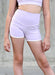 Person wearing light purple athletic shorts against a neutral background