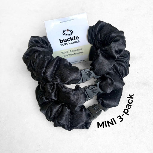 Black scrunchies with a 'buckle' brand card on a white background