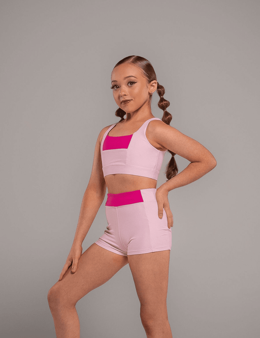 Person wearing a pink and magenta sports outfit on a gray background