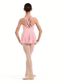 Person wearing a pink leotard with a white background