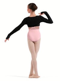Ballerina in a black long-sleeve top and pink leotard on a white background